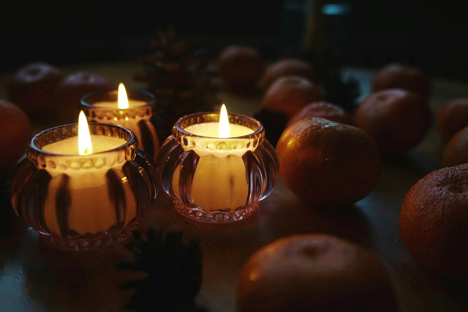 Candles sitting on a table with soft lighting