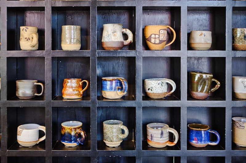 Assorted color mugs on a wooden rack